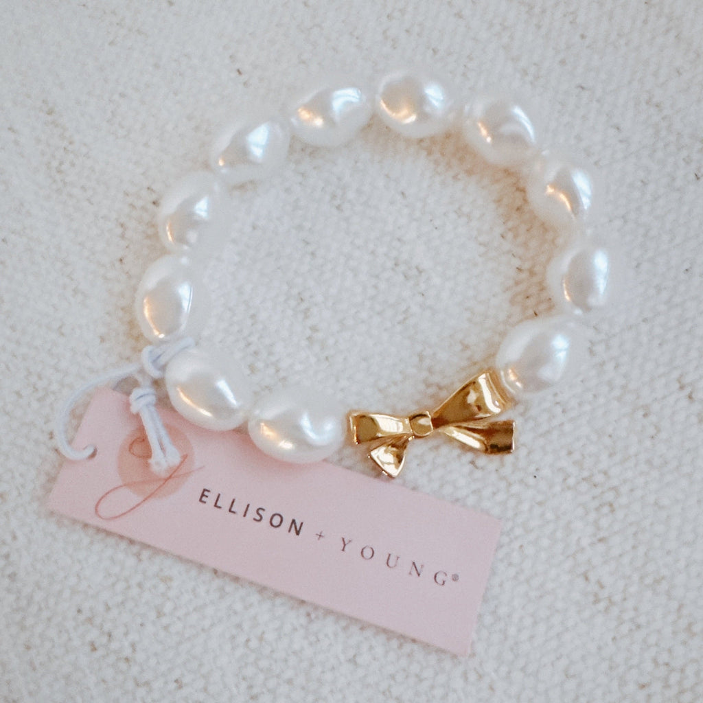 Elastisches Armband mit Goldschleife und Perlen